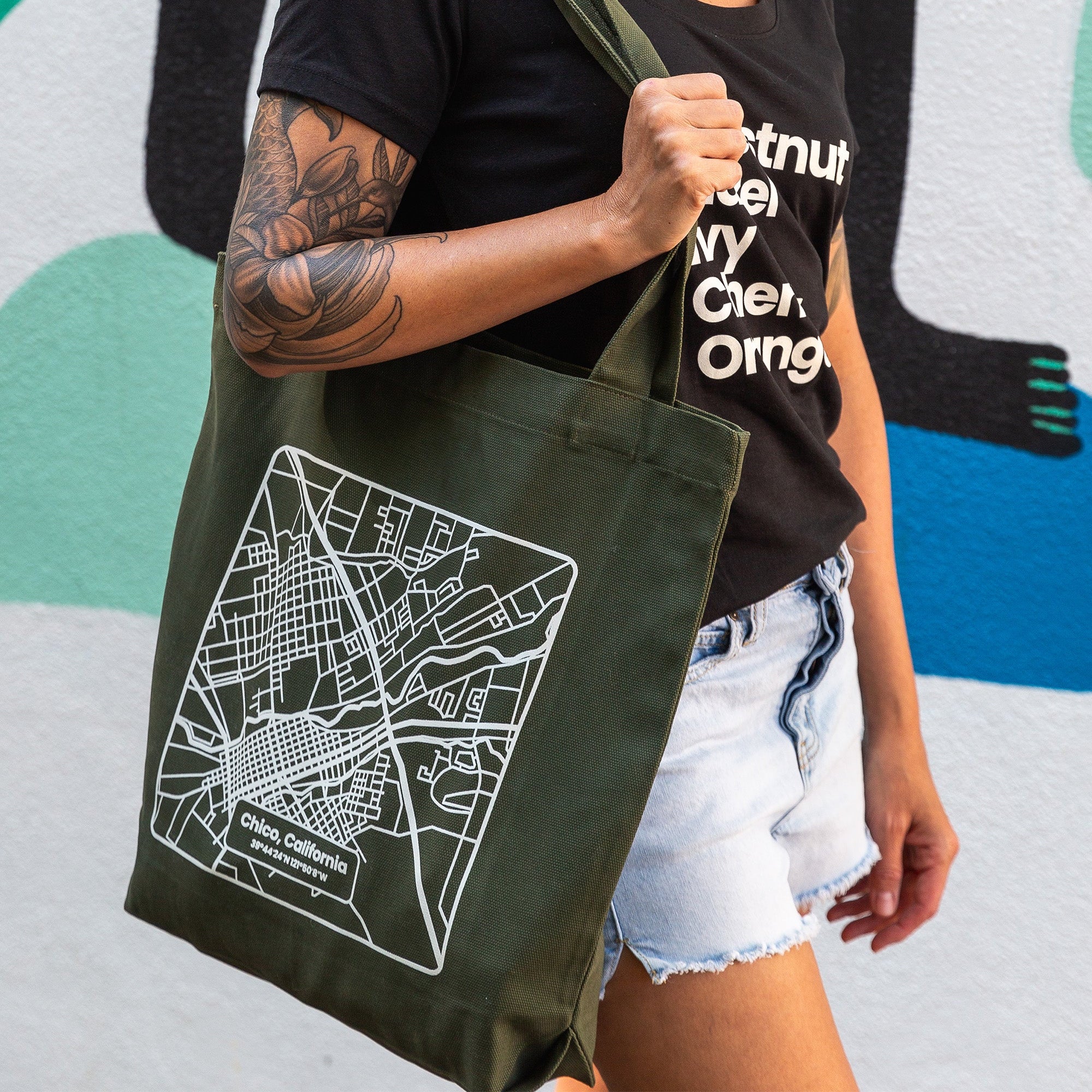Woman carrying a Chico Streets Map Carrie Tote Bag from Upper Park Clothing in Chico, Ca