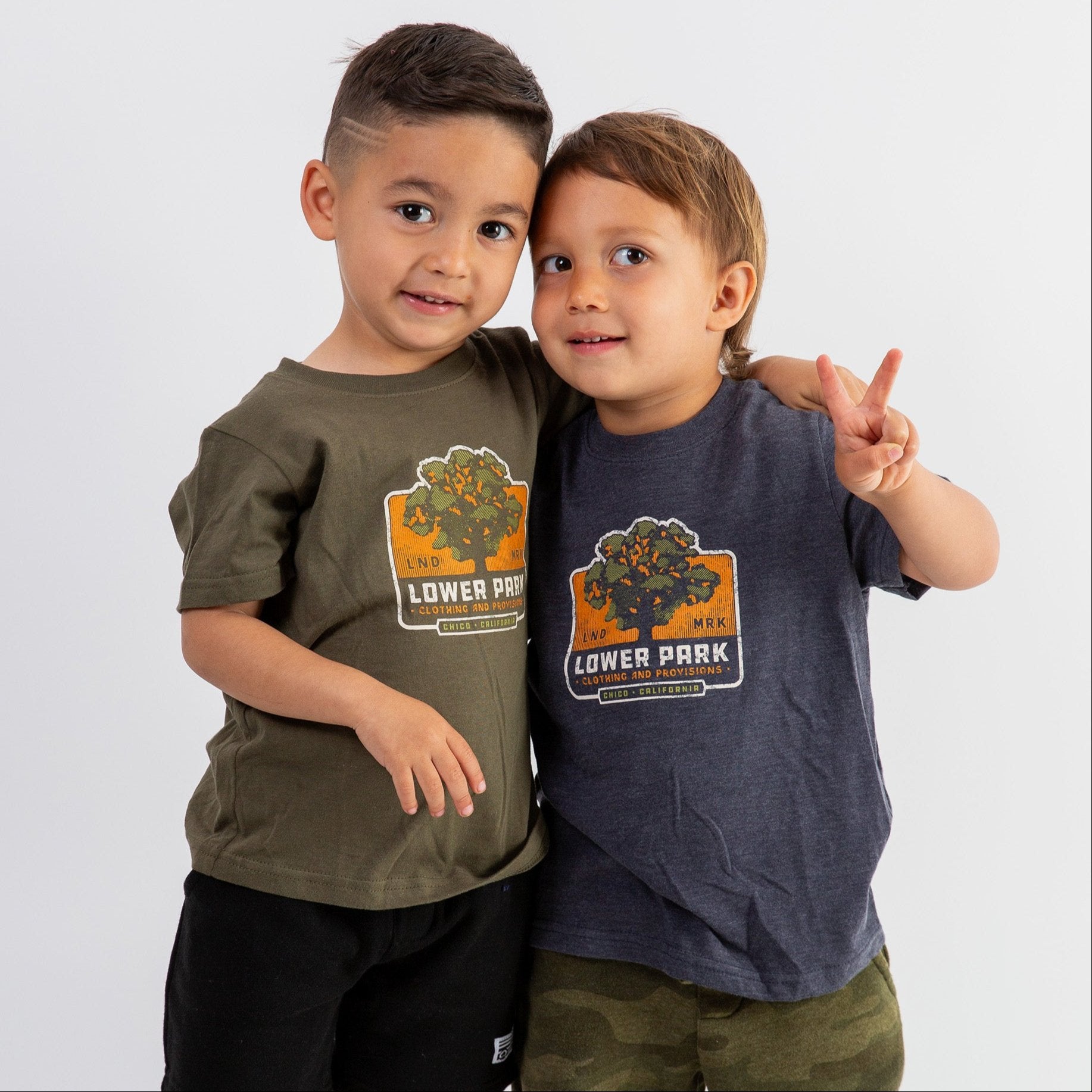 2 kids wearing a Little Oak Toddler Tee from Upper Park Clothing in Chico, Ca