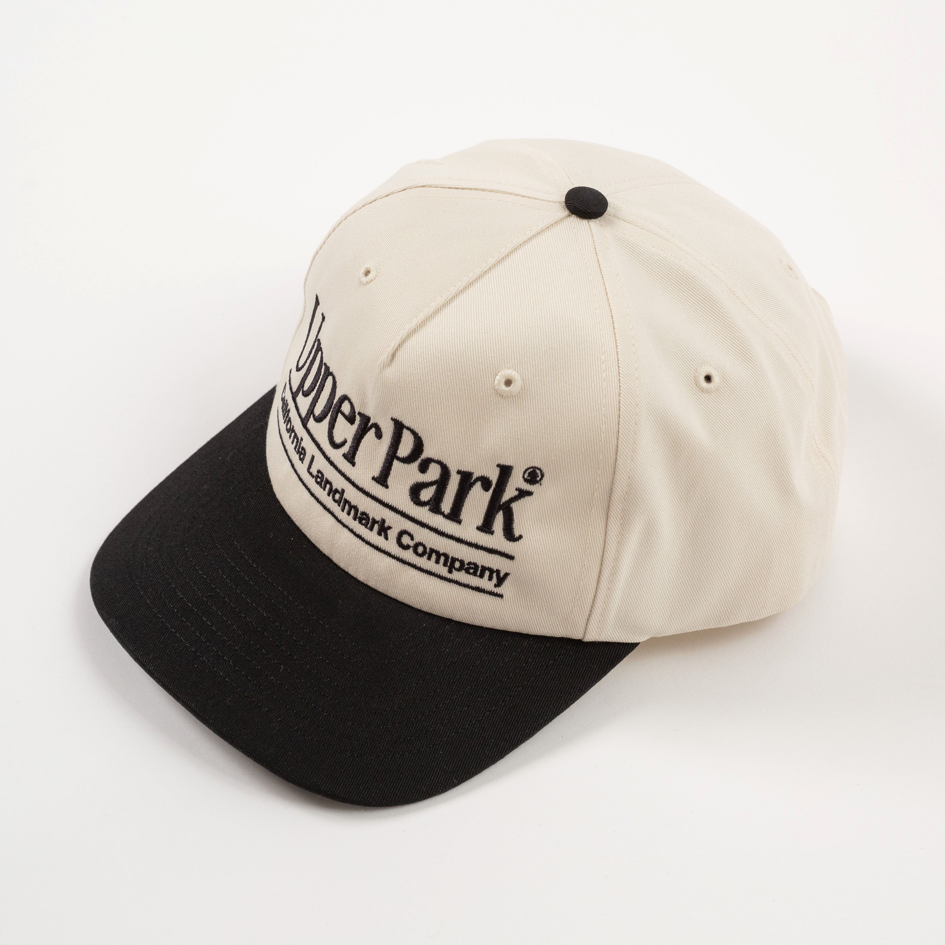 Overhead Cream and black cap with 'Upper Park' logo on a white - California Landmark Companybackground