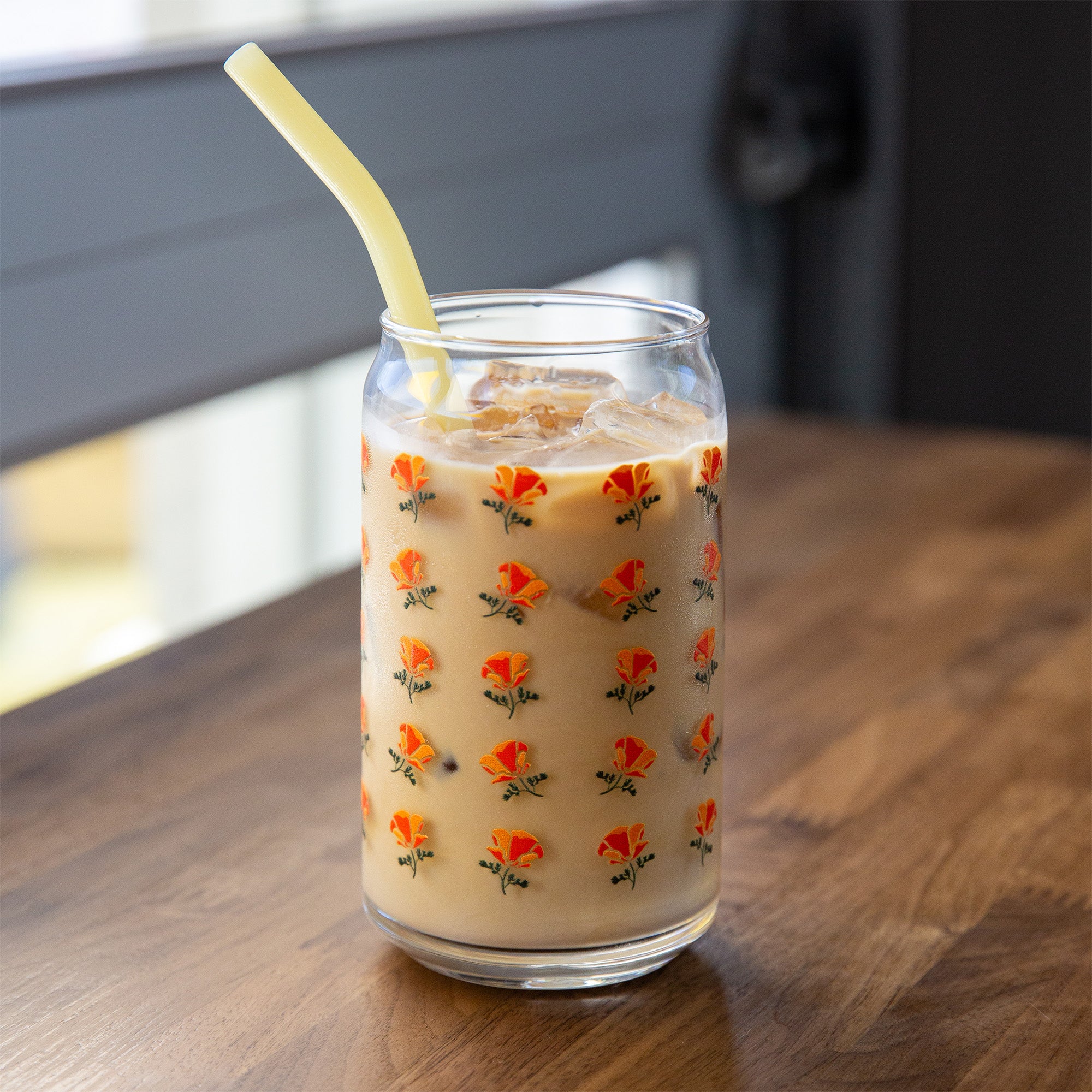 A california poppy pattern beer can glass filled with coffee. Upper Park Clothing - Chico, Ca