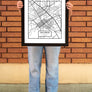 women standing in front of a brick wall in Downtown Chico holding a Chico Streets Map Poster in a Frame from Upper Park Clothing