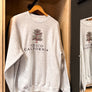 Chico City of Trees Thrifty Crew Neck Sweater hanging up inside Upper Park Clothing's Downtown Chico California Store