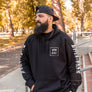 man standing on the stairs on Esplanade Street in Chico California while wearing a Esplanade Outlaws Supply Hoodie from Upper Park Clothing