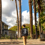 man walking across the Barber Street in Downtown Chico California wearing a Esplanade Outlaws Washed Long Sleeve from Upper Park Clothing