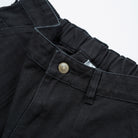 Men's Shorts Heavy Duck Canvas - Upper Park Clothing - Close-up of black pants with a button on a white background