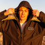 man leaning against a rail at Horseshoe Lake in Upper Bidwell Park wearing a workwear back from Upper Park Clothing