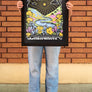 women standing in front of a brick wall in Downtown Chico holding a Table Mountain Poster in a Frame from Upper Park Clothing