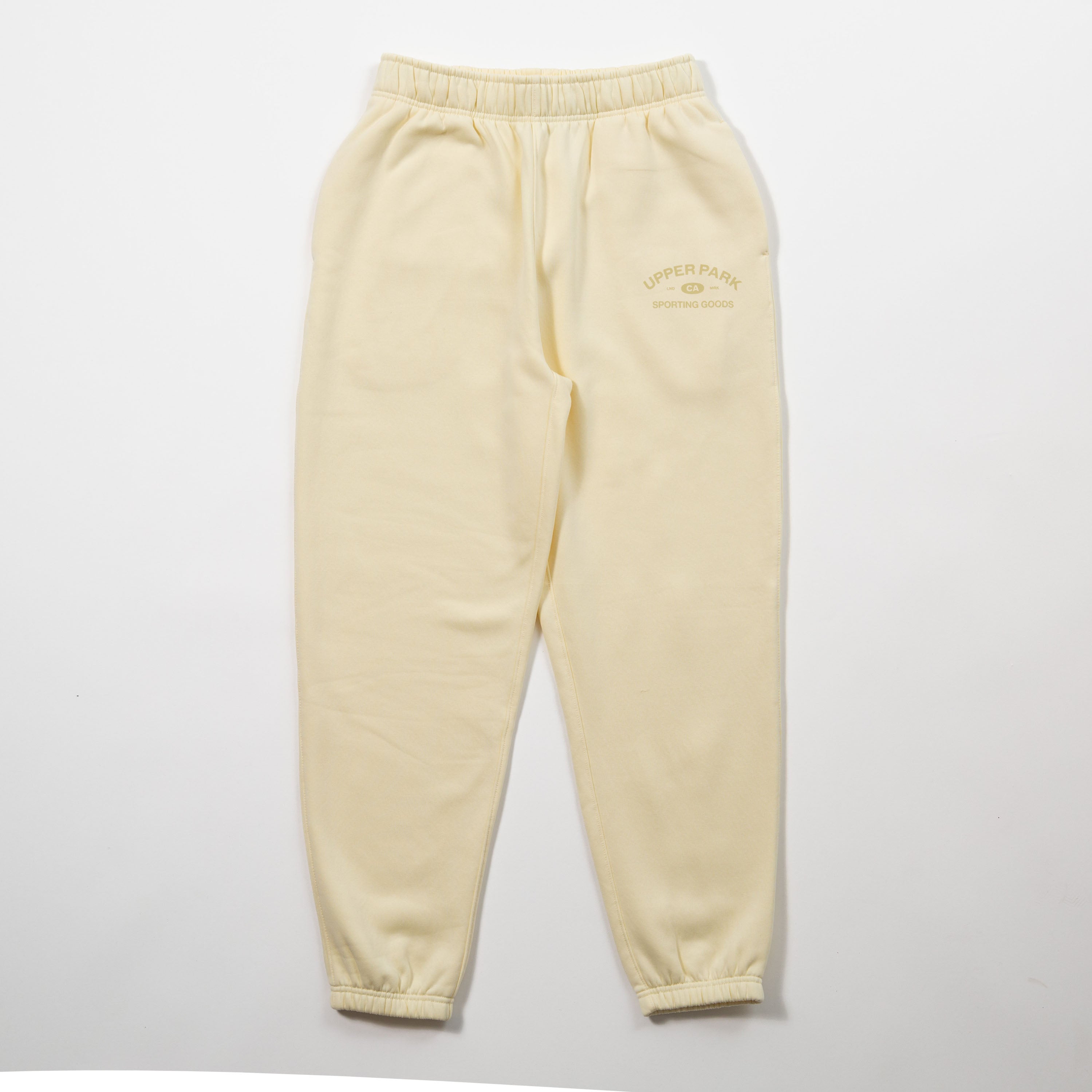 Yellow sweatpants with a brand logo on a light gray background - Upper Park Athletics Sweatpants Set
