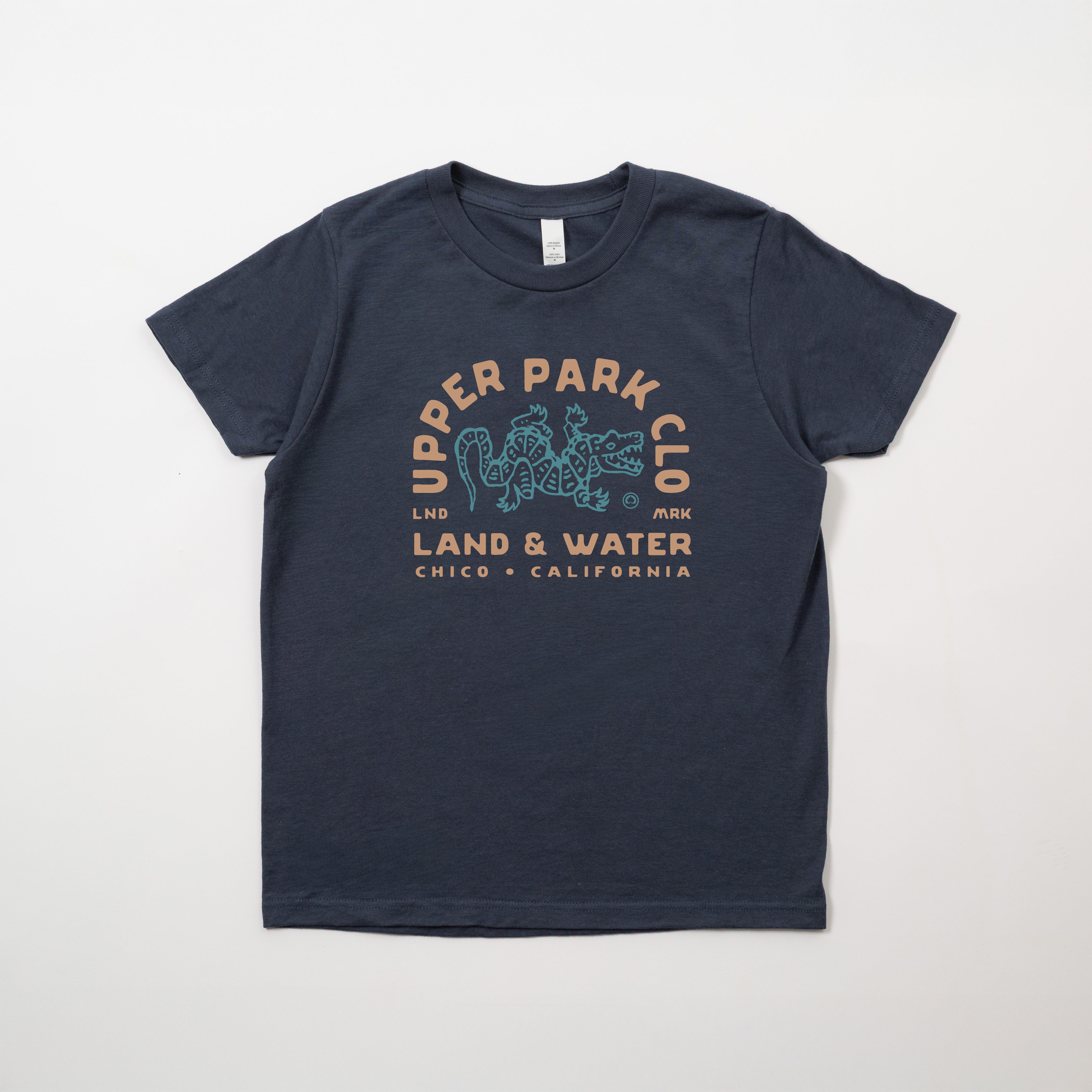 Navy blue t-shirt with 'Upper Park' logo on a light gray background - Alligator Hole Shirt Upper Park Clothing