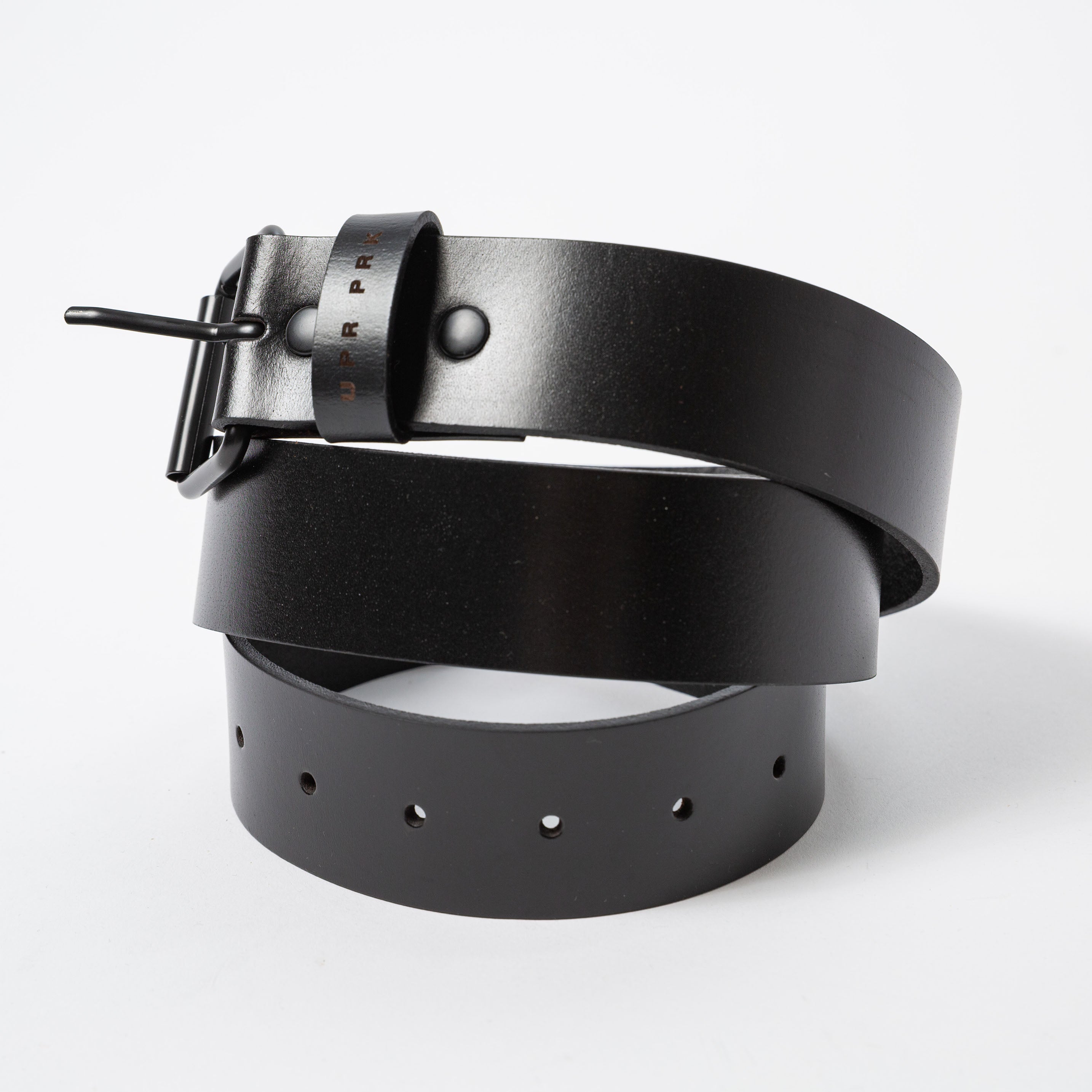 black leather belt horizontally rolled up and laying on it's side - Upper Park Basic Leather Belt