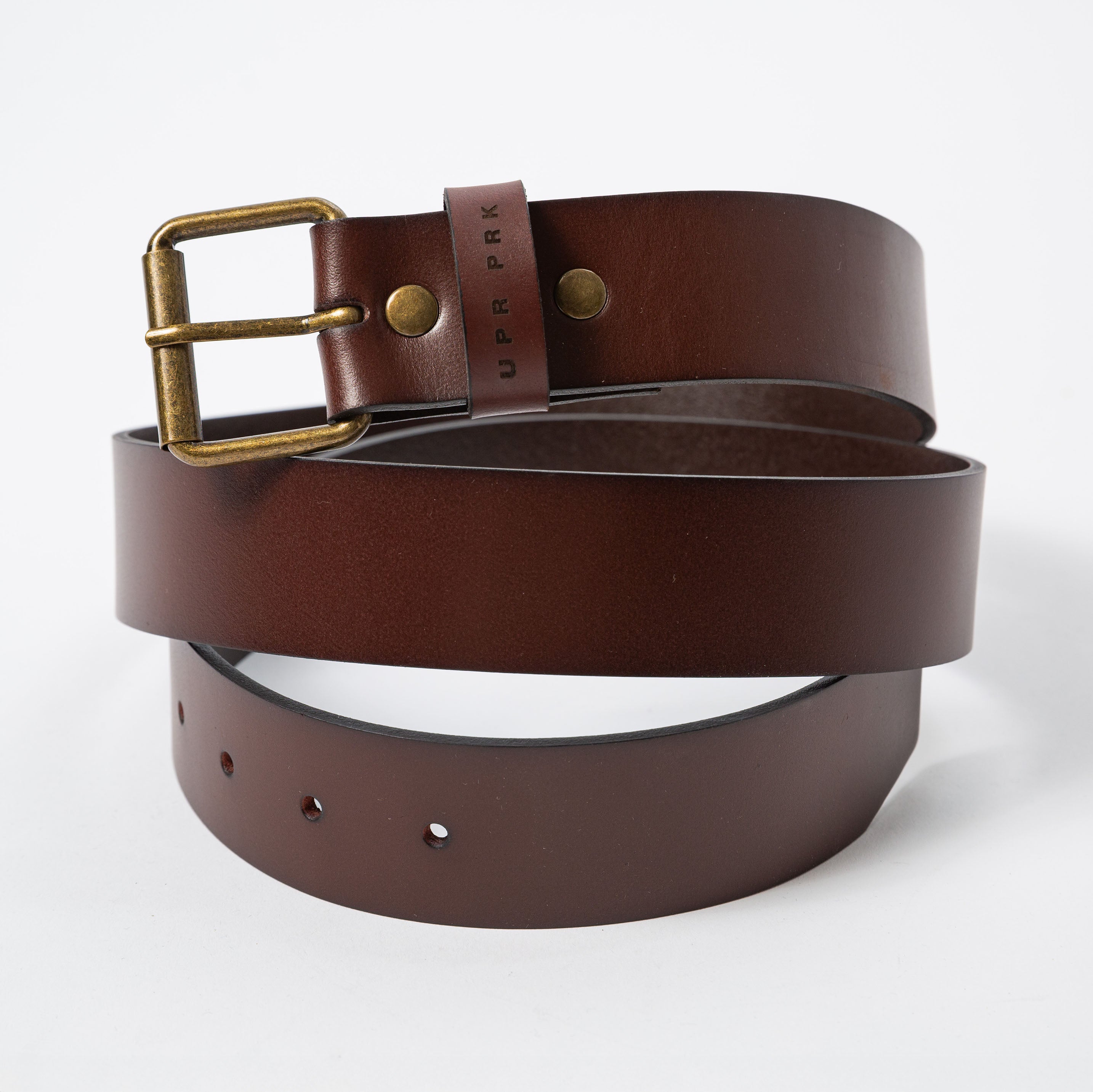 brown leather belt horizontally rolled up and laying on it's side - Upper Park Basic Leather Belt