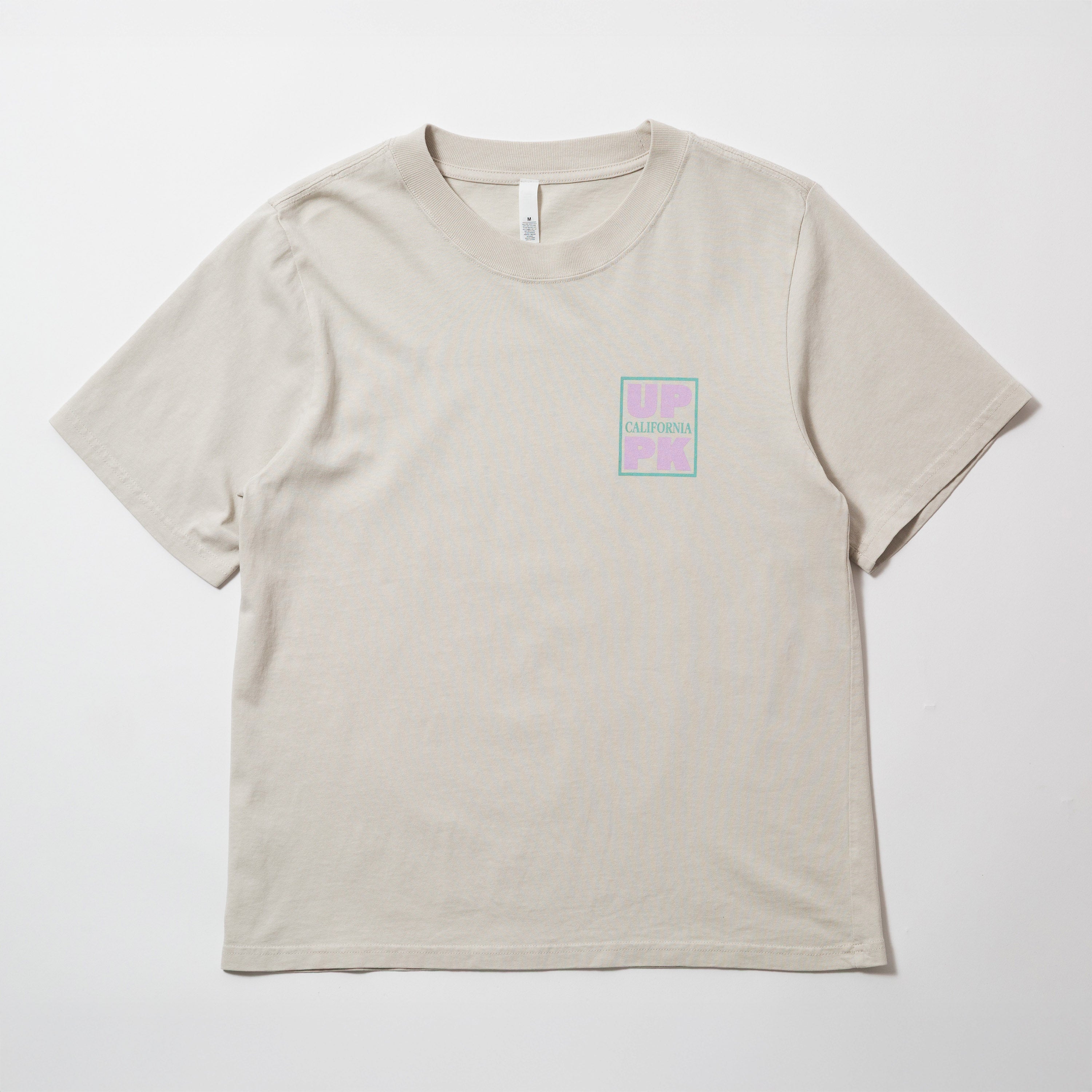 Upper Park Discovery Graphic Women's Tee - Beige t-shirt with a small logo on a white background