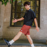 man standing on the stairs in front of the U.S Post Office in Downtown Chico wearing clay walk shorts from Upper Park Clothing