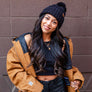women standing in front of a blank wall in Downtown Chico wearing a workwear jacket from Upper Park Clothing
