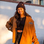 women standing in front of a blank wall in Downtown Chico wearing a workwear jacket from Upper Park Clothing