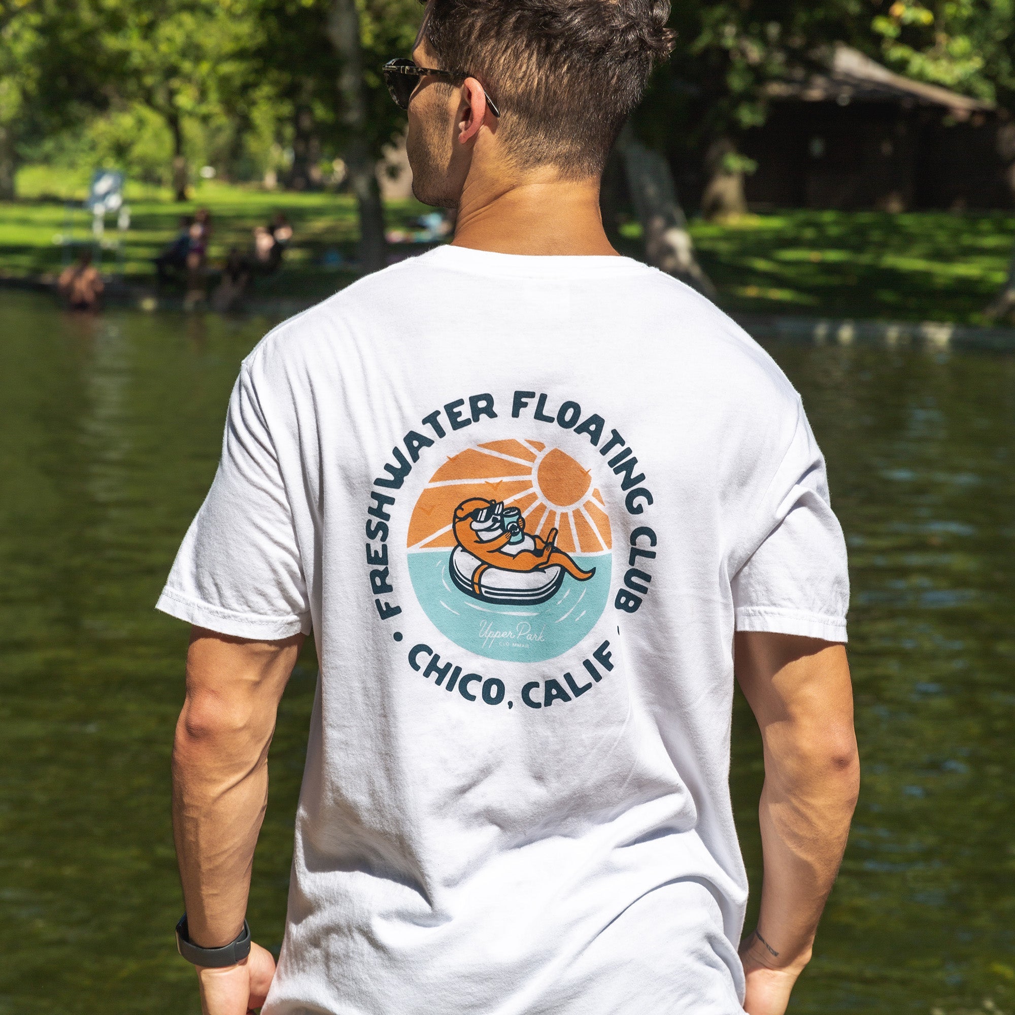 Man wearing a Freshwater Floating Club Washed Tee from Upper Park Clothing  at One Mile swimming pool in Chico, Ca