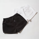 Basics Women's Heavy Fleece Cotton Shorts - Black and white shorts on a light gray background