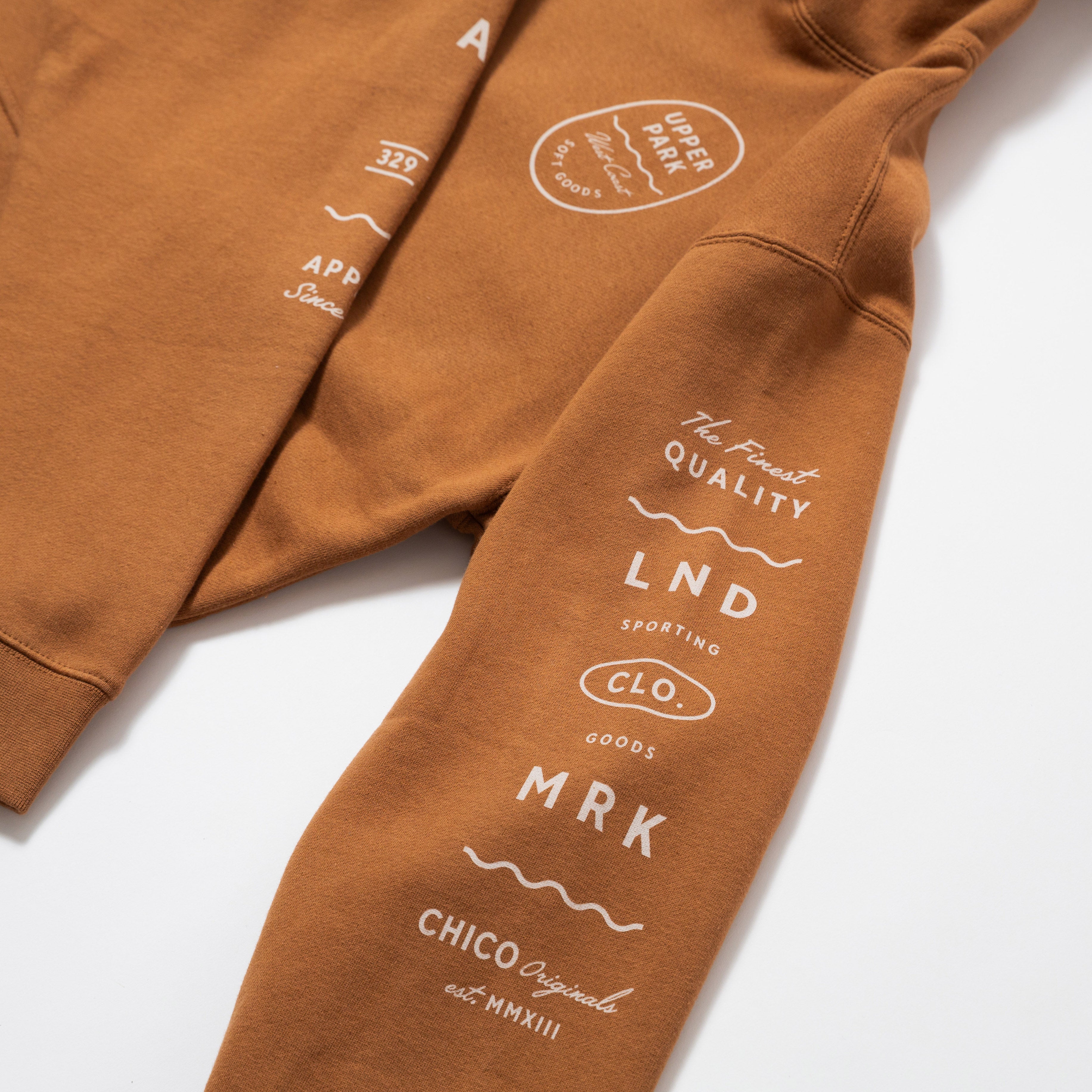 Upper Park Bay Waves Mid weight Hooded Sweatshirt - Brown hoodie with white text and branding on a white background