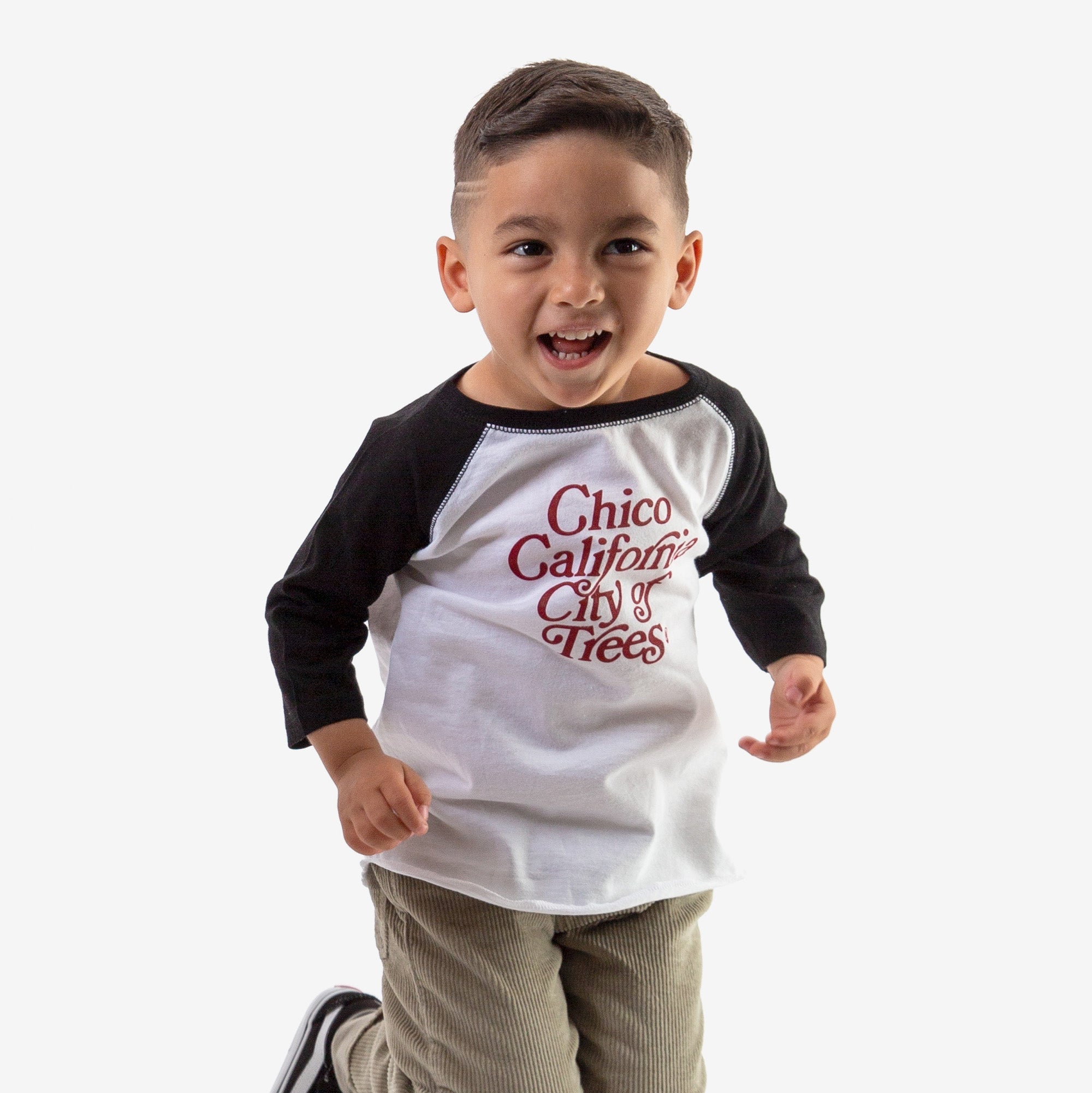 Boy wearing a Bookman Graphic Toddler Baseball Tee from Upper Park Clothing in Chico, Ca