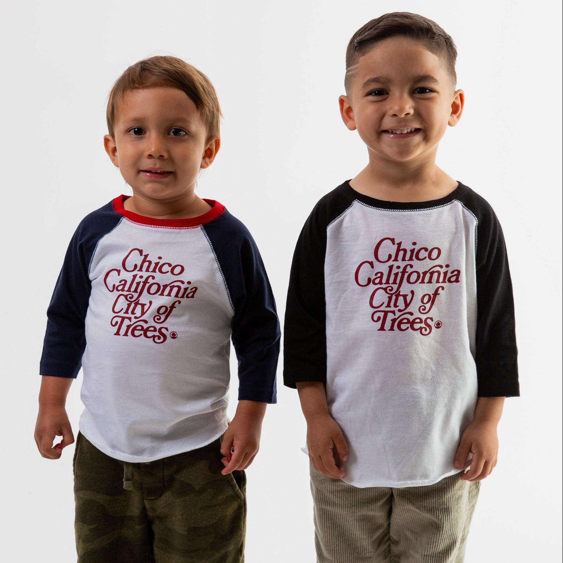 Two boys wearing Bookman Graphic Toddler Baseball Tees from Upper Park Clothing in Chico, Ca