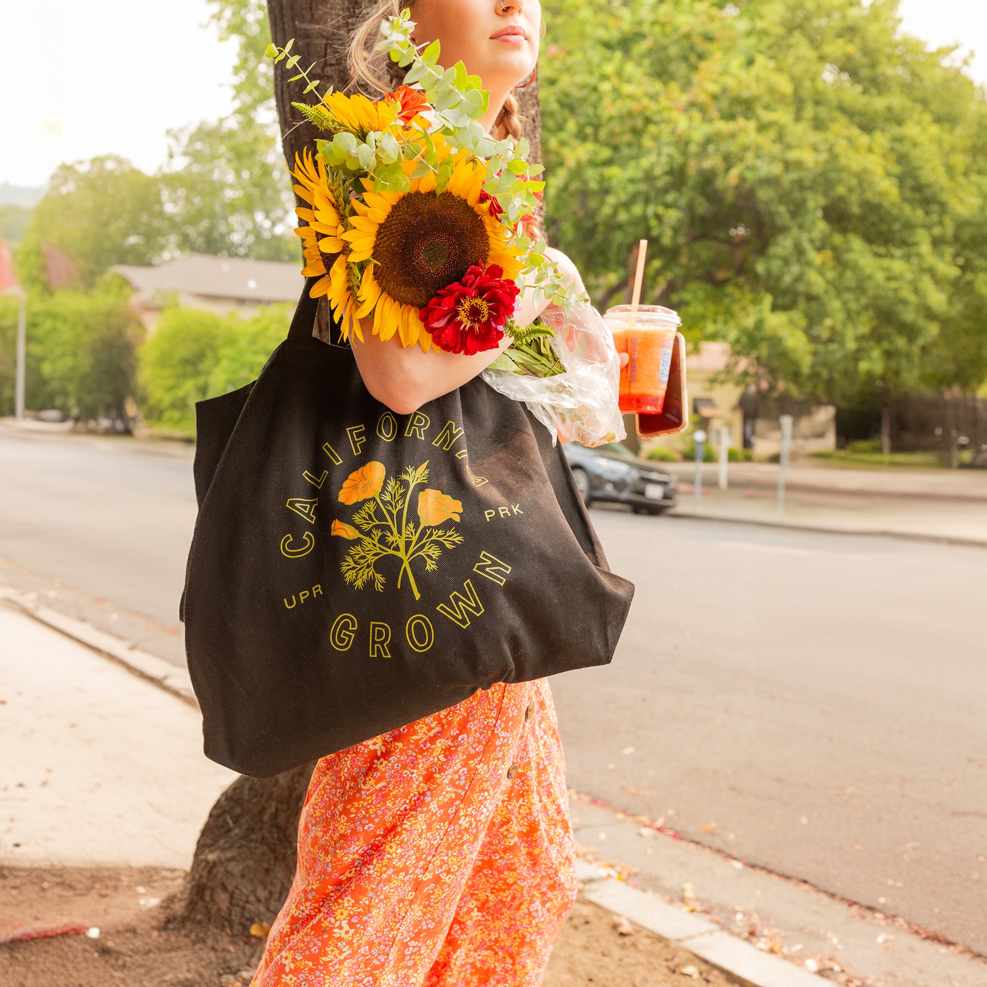 Woman holds a California Grown Tote Bag and a bouquet of flowers - Upper Park Clothing - Chico, CA