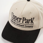 Detail cream and black cap with 'Upper Park' logo on a white background - California Landmark Company