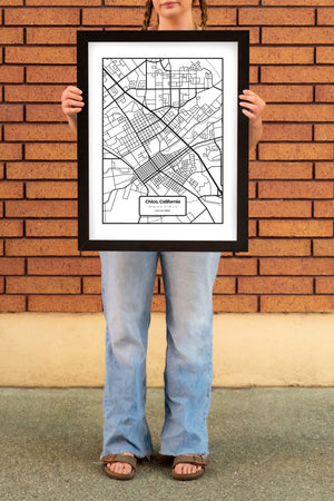 women standing in front of a brick wall in Downtown Chico holding a Chico Streets Map Poster in a Frame from Upper Park Clothing