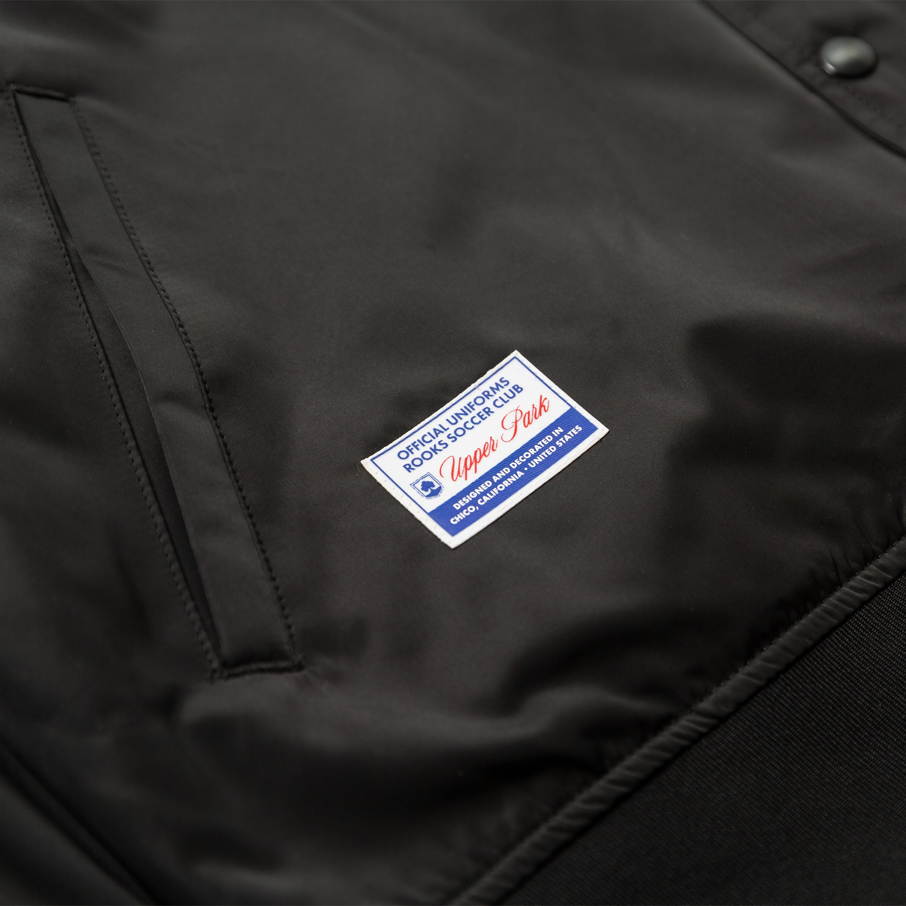 Chico Rooks Soccer Club x Upper Park Jacket - Black jacket with a visible brand label on the chest.