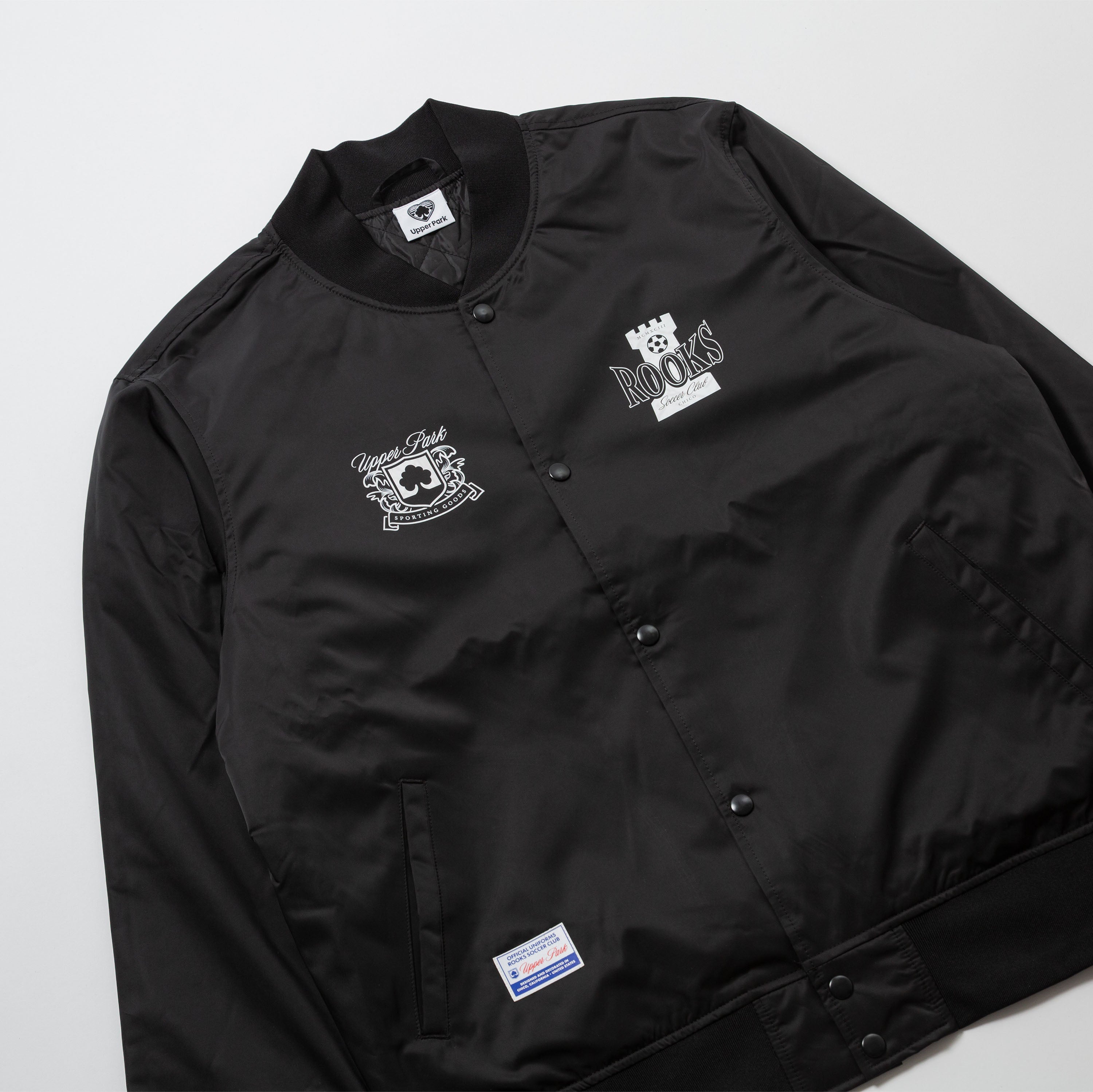 Chico Rooks Soccer Club x Upper Park Jacket - Black jacket with embroidered logos on a white background