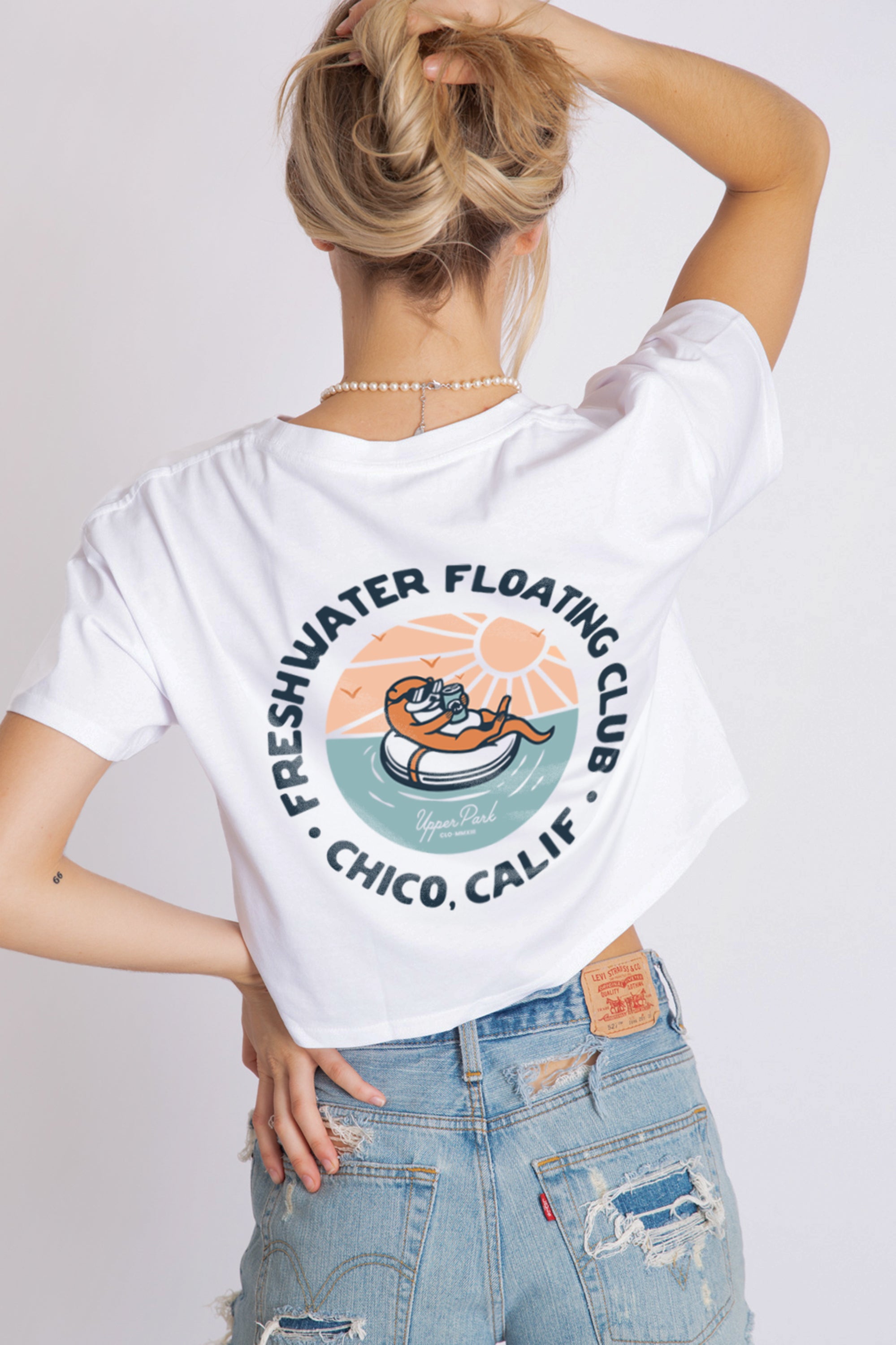 women standing in a photography studio wearing a Freshwater Floating Club crop tee from Upper Park Clothing