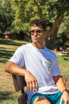 man walking at One Mile Sycamore Pool wearing a Freshwater Floating Club tee and Pro Label Beach Shorts from Upper Park Clothing 