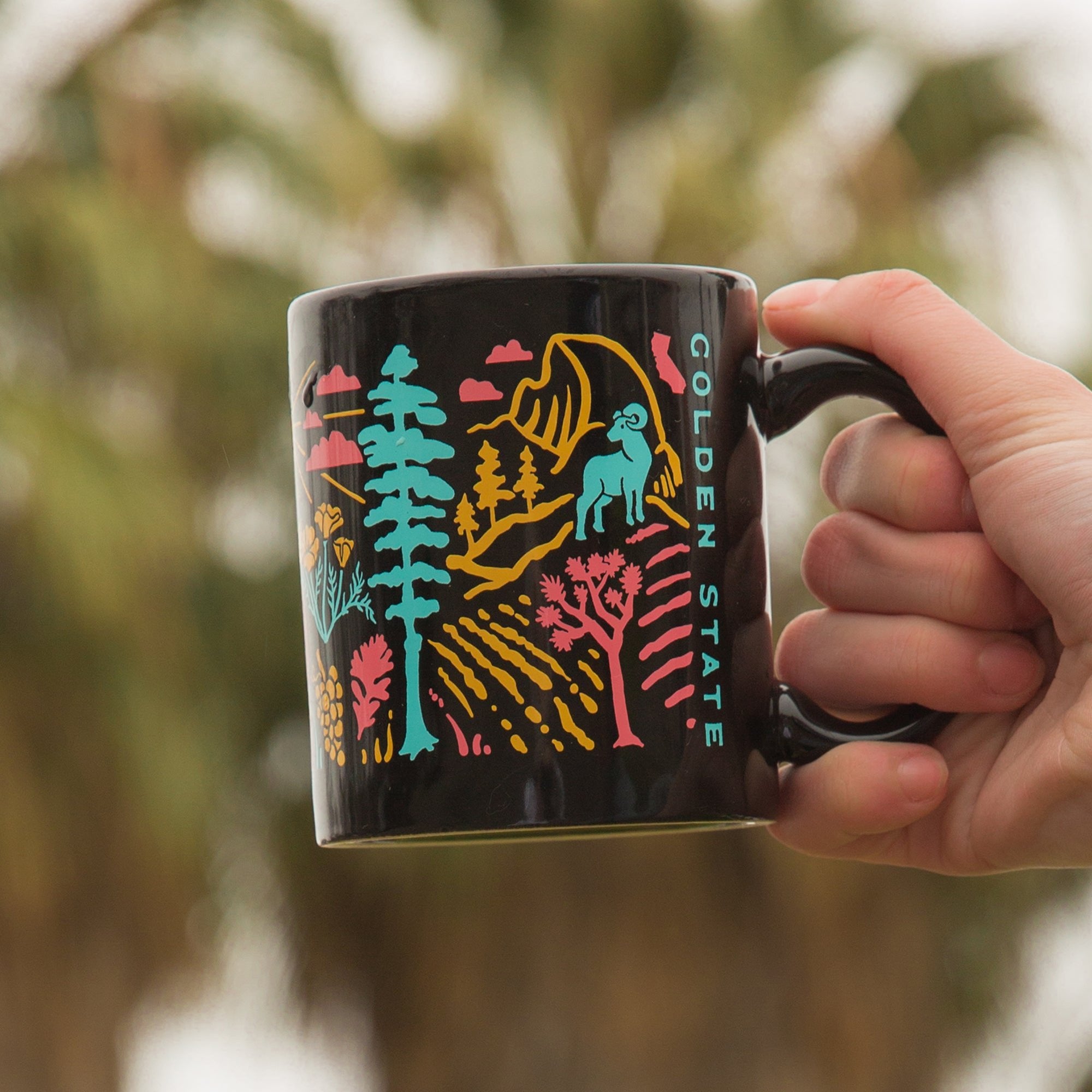 Hand holding a Golden State Mug from Upper Park Clothing in Chico, Ca