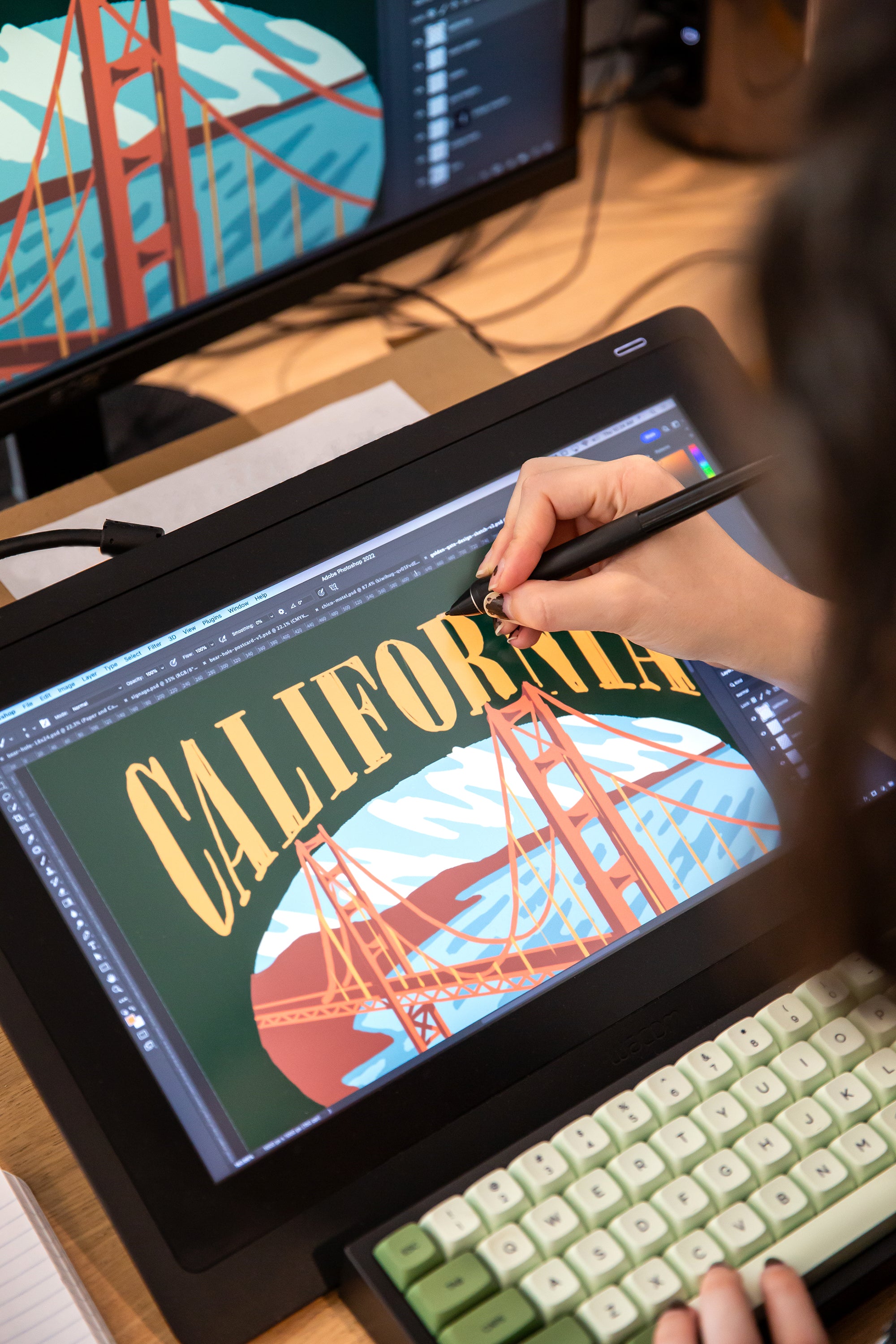 women drawing on a wacom tablet drawing the Golden Gate Bridge in San Francisco California new graphic Golden State Embroidery at Upper Park Clothing in Chico,CA