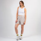 Woman wearing a white tank top and beige shorts on a white background - Upper Park Basics - Garment Dyed Relax Shorts