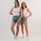 Two women wearing white tank tops and shorts on a plain background - Cotton Gym Shorts