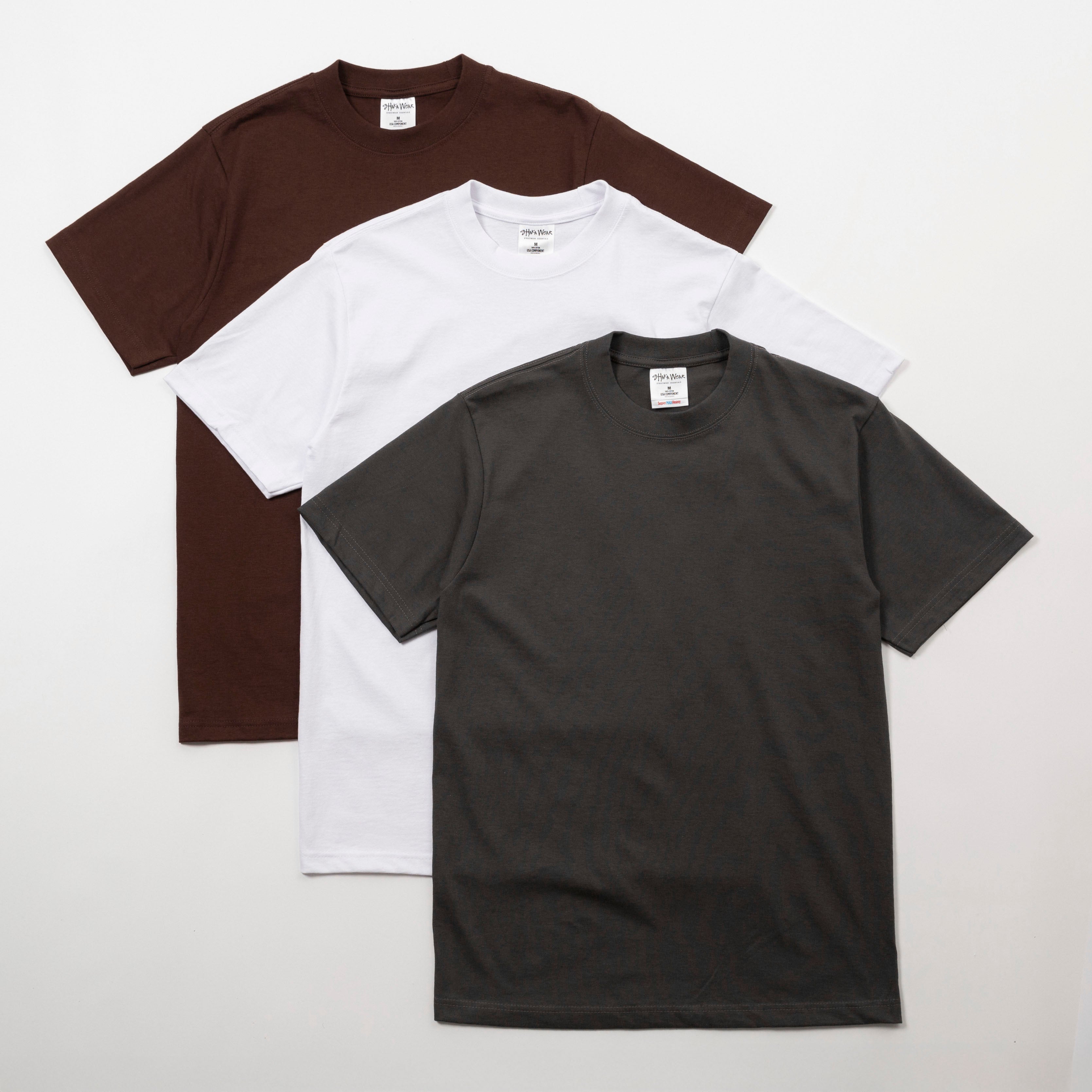 Three plain t-shirts in brown, white, and black on a light gray background - Shaka Wear 7.5oz Heavyweight Cotton Tee