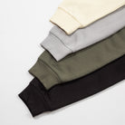 Close up of hoodie sleeves black, green, gray, and beige on a light gray background- Upper Park Athletics Hoodie Set
