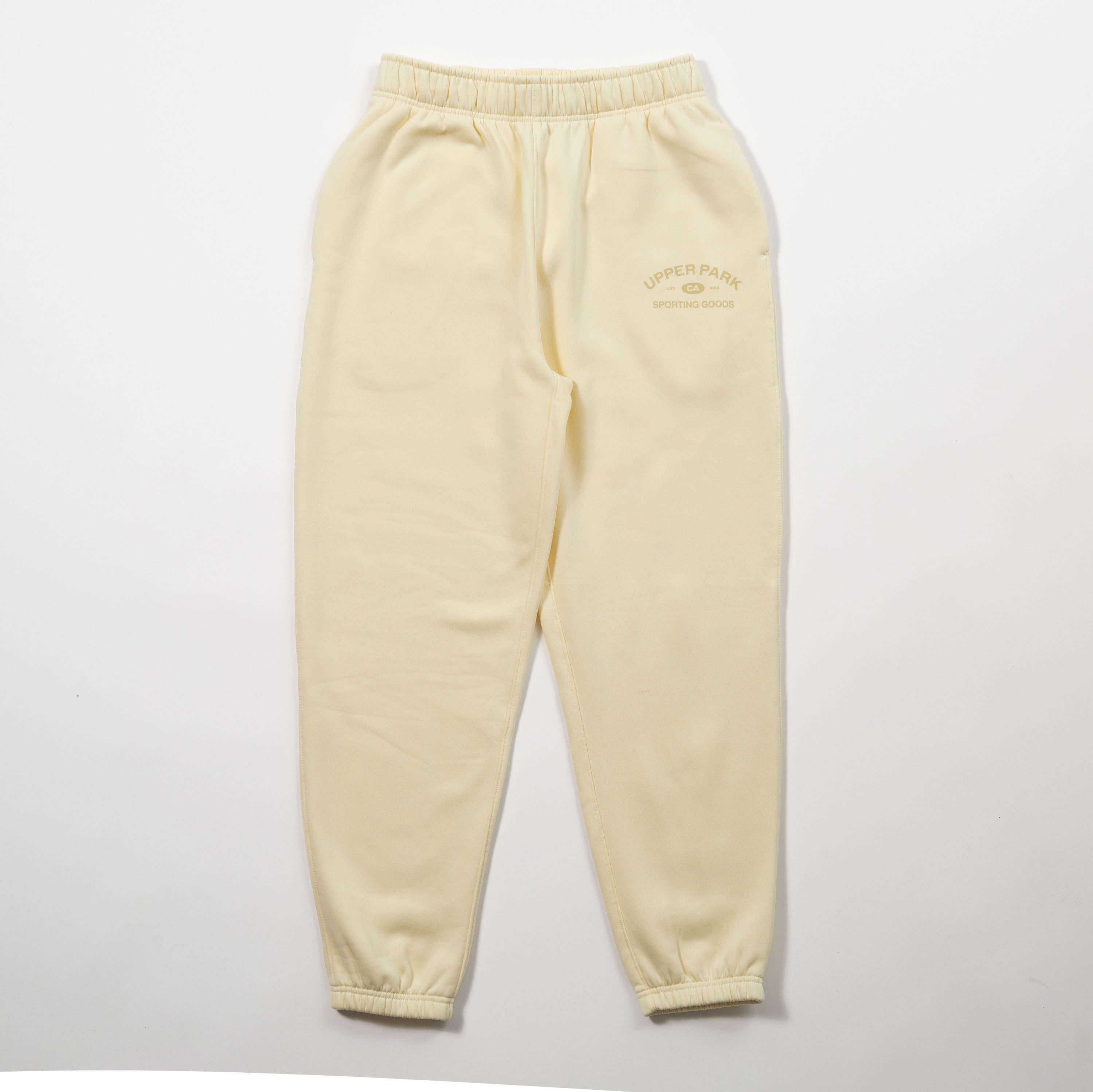Yellow sweatpants with a brand logo on a light gray background - Upper Park Athletics Sweatpants Set