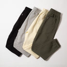 Four pairs of sweatpants in black, gray, yellow, and green on a light gray background - Upper Park Athletics Sweatpants Set