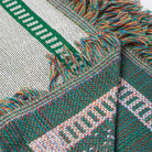 Close-up of a woven fabric with green, white, and multicolor pattern - Upper Bidwell Park Woven Blanket