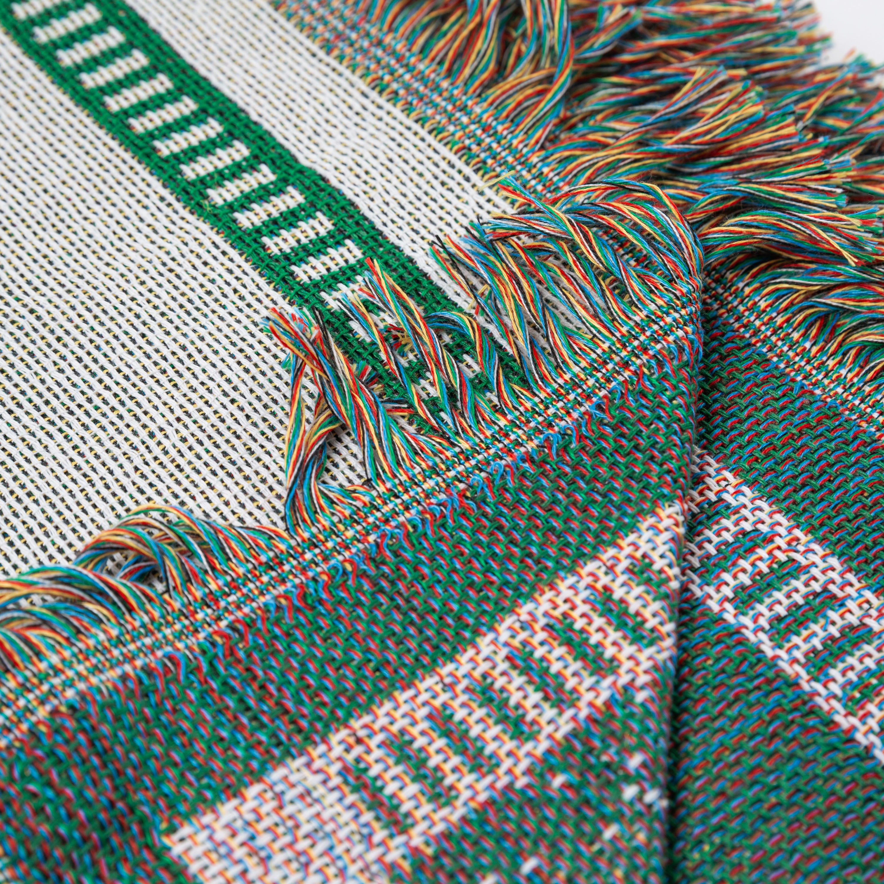 Close-up of a woven fabric with green, white, and multicolor pattern - Upper Bidwell Park Woven Blanket