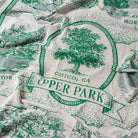 Fabric with green and white design of a tree and text 'Upper Park, Chico, CA'.  - Upper Bidwell Park Woven Blanket