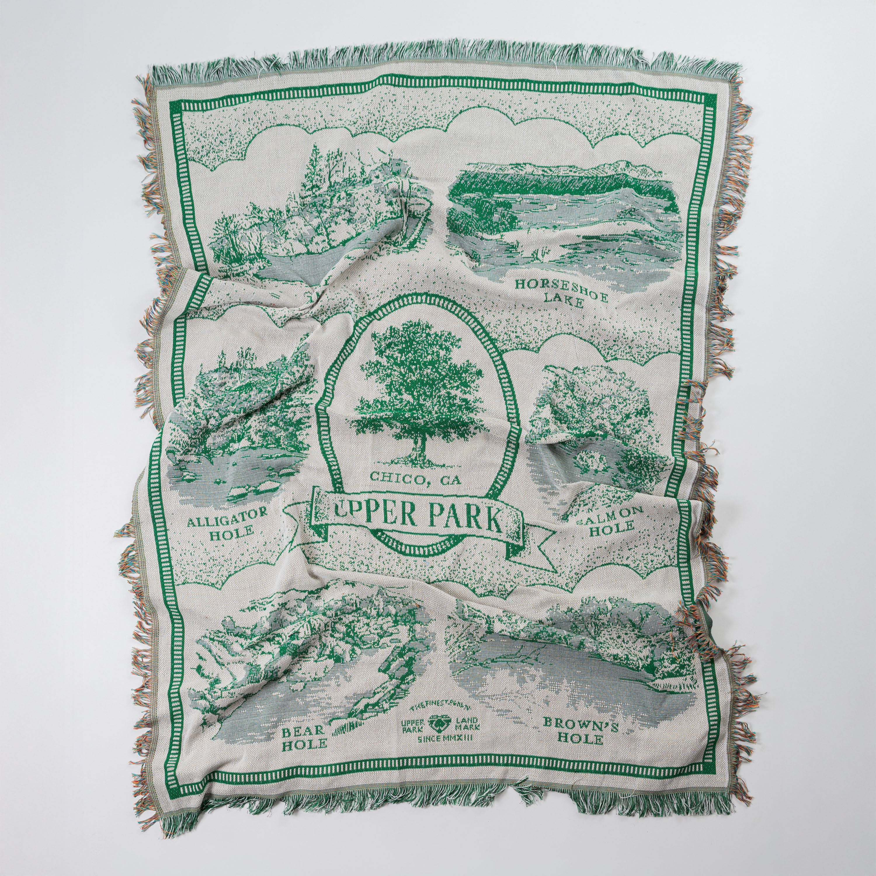 Green and white patterned blanket with text and images on a white background - Upper Bidwell Park Woven Blanket