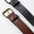 brown and black leather belts laid out showing a detail of the top metal buckle and etching of UPR PRK - Upper Park Basic Leather Belt