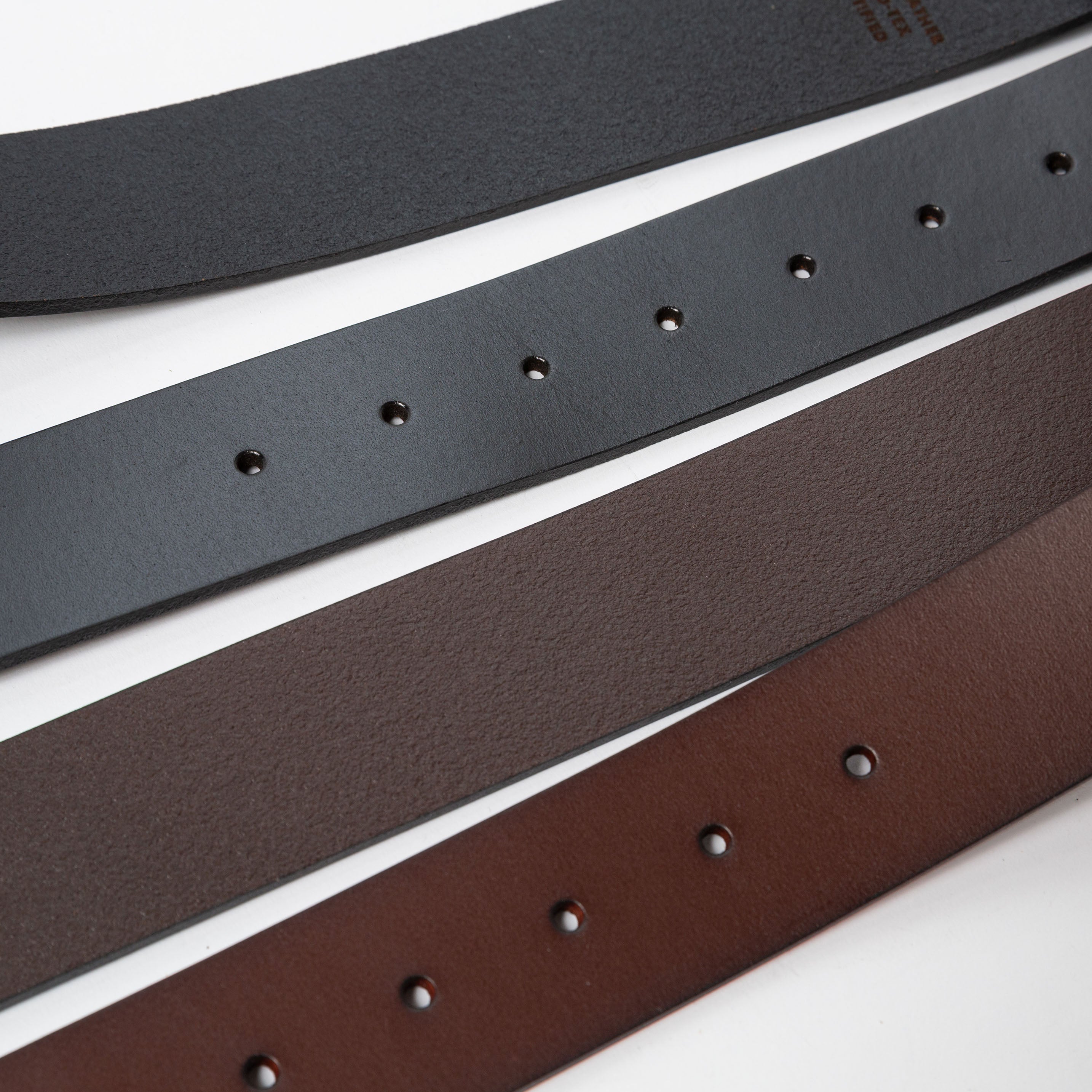 a close up of two leather belts showing the underside and top side textures with the loop holes - Upper Park Basic Leather Belt