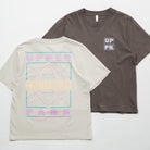 Upper Park Discovery Graphic Women's Tee - Two t-shirts, one gray with a logo on the chest and one beige with a geometric design, on a white background.
