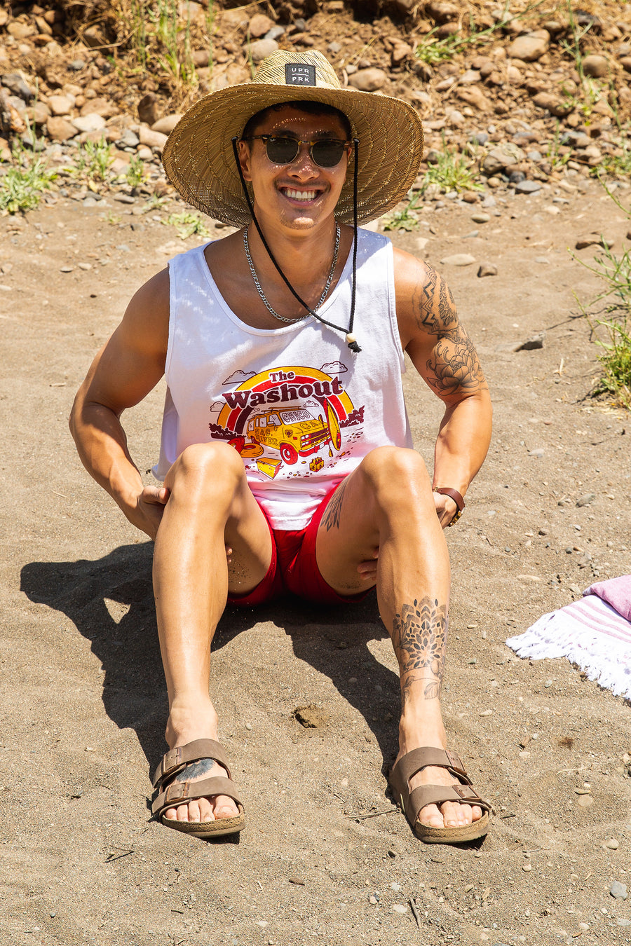 man sitting on a beach in Upper Bidwell Park while wearing a Washout Tank from Upper Park Clothing