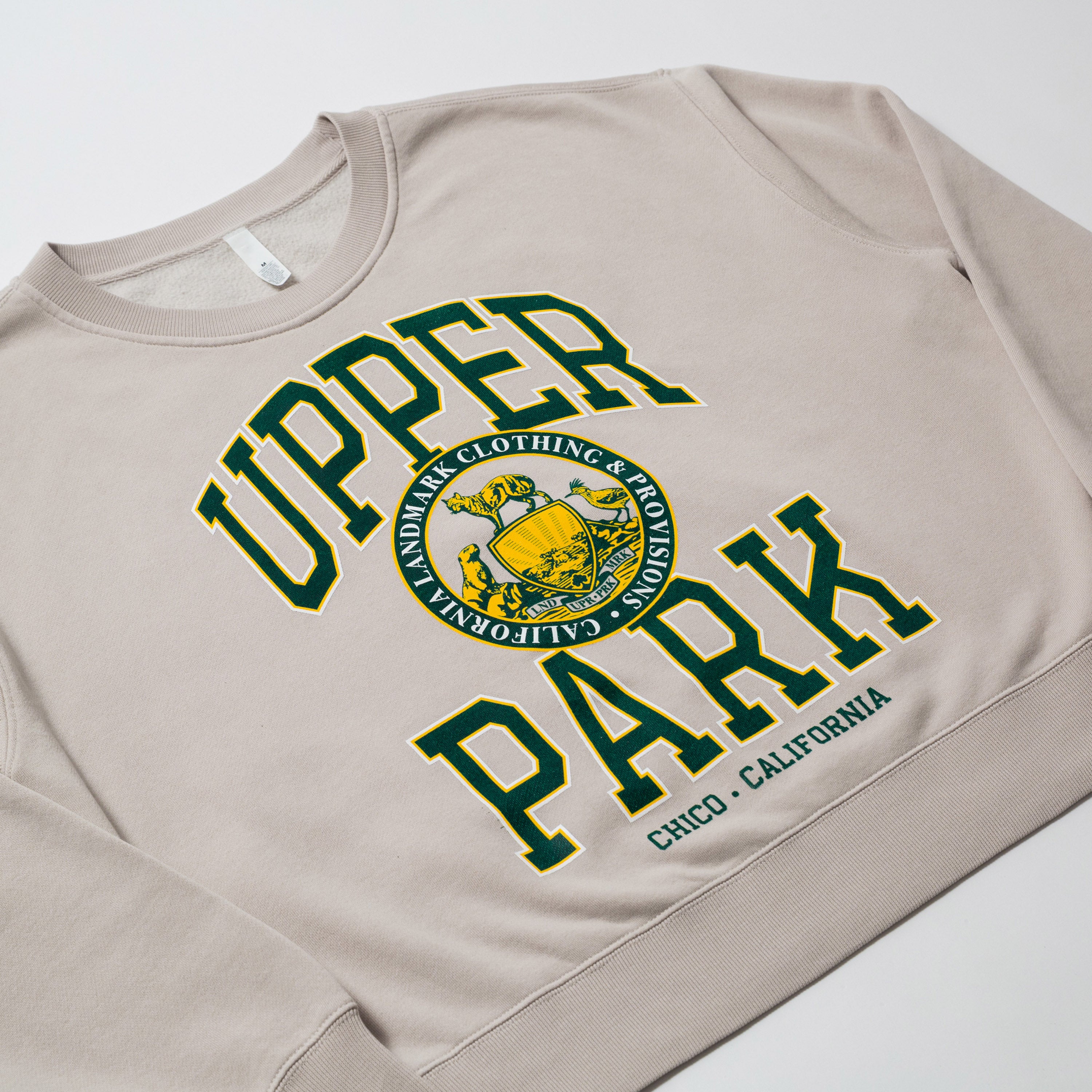 Women's Campus Crew Sweatshirt - Beige sweatshirt with 'Upper Park' text and logo on a white background
