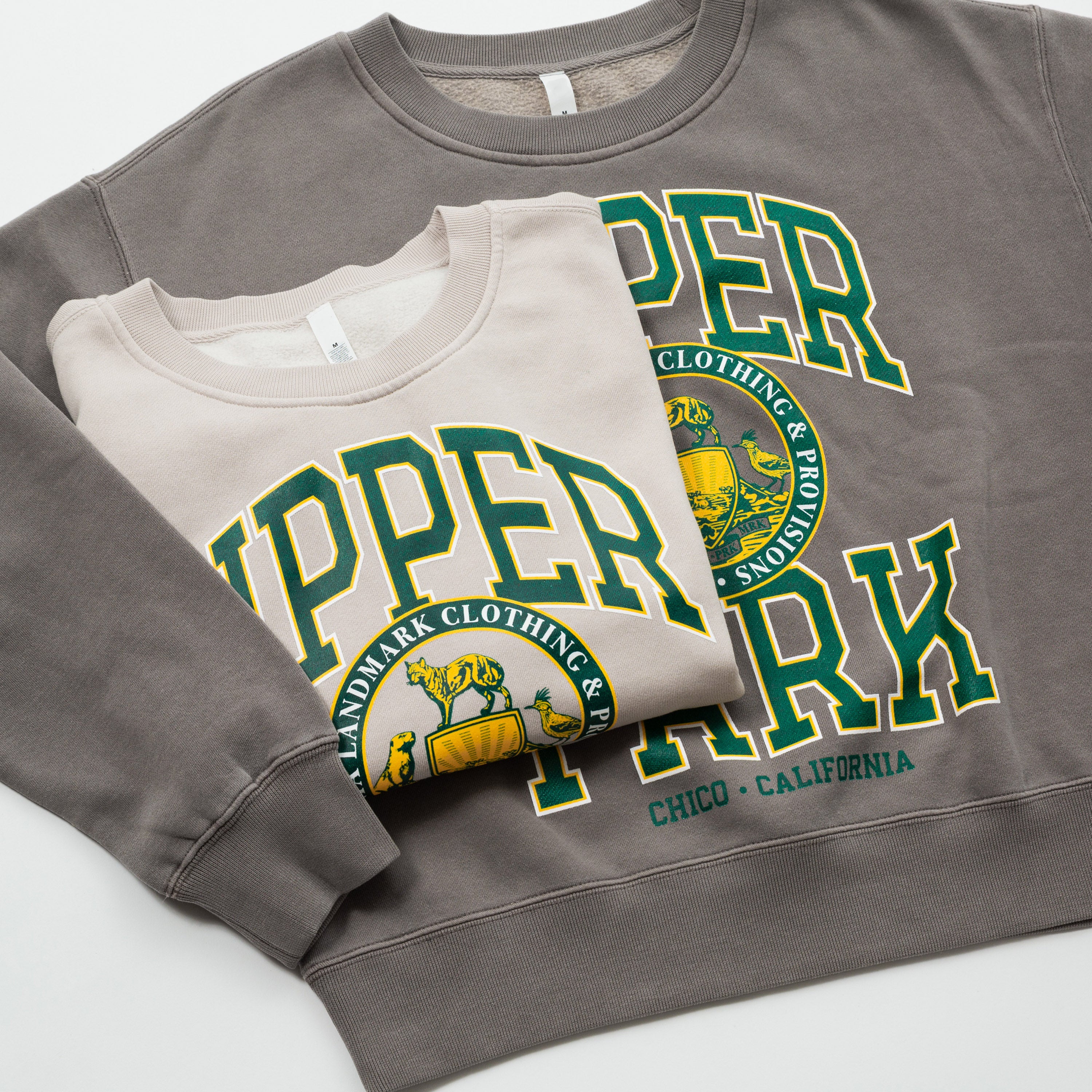 Women's Campus Crew Sweatshirt - Two sweatshirts with a prominent logo and text on a light gray background