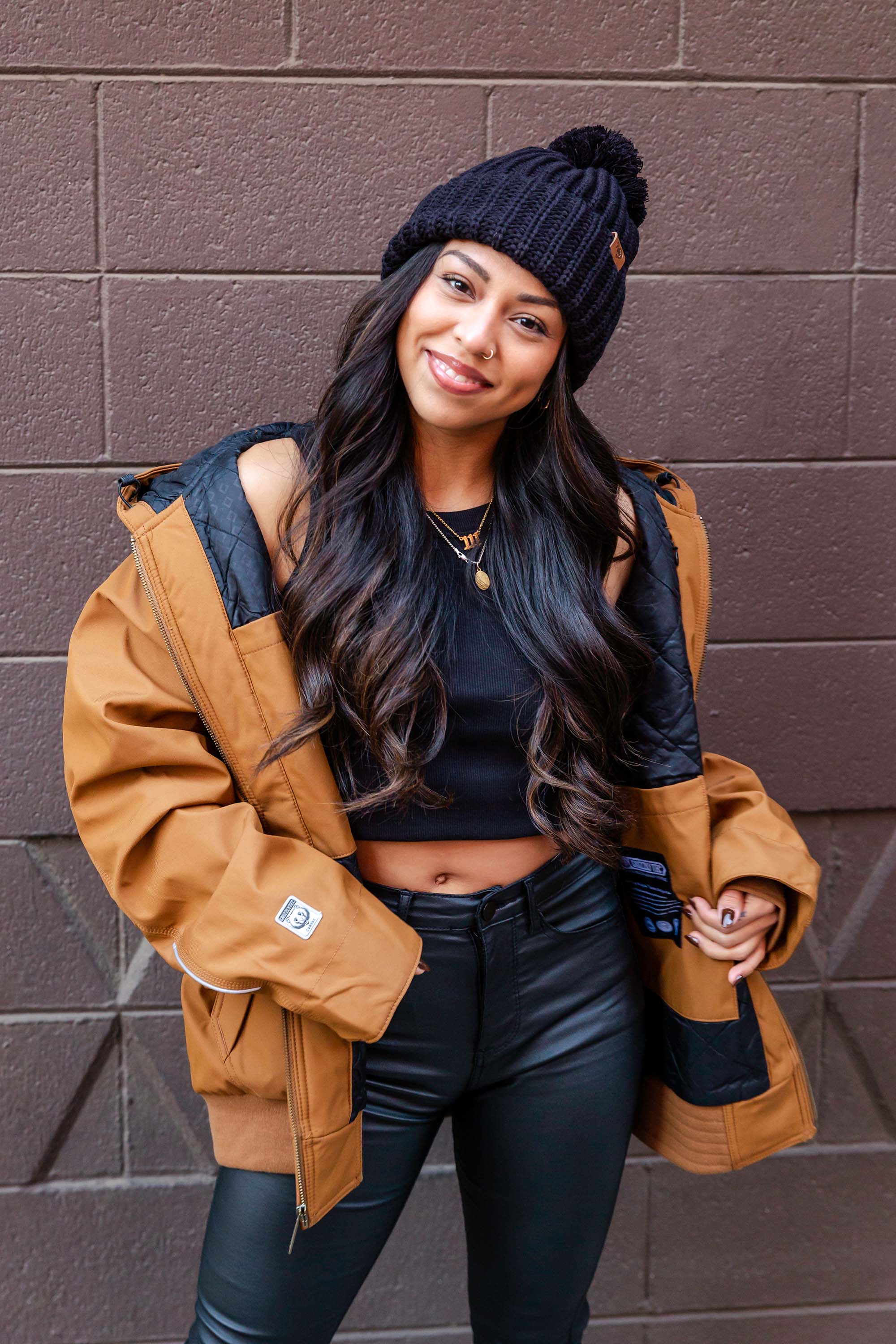 women standing in front of a blank wall in Downtown Chico wearing a workwear jacket from Upper Park Clothing